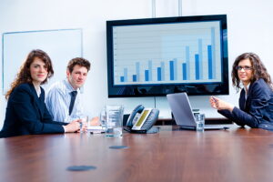 BBA graduates in a meeting sitting around a conference table